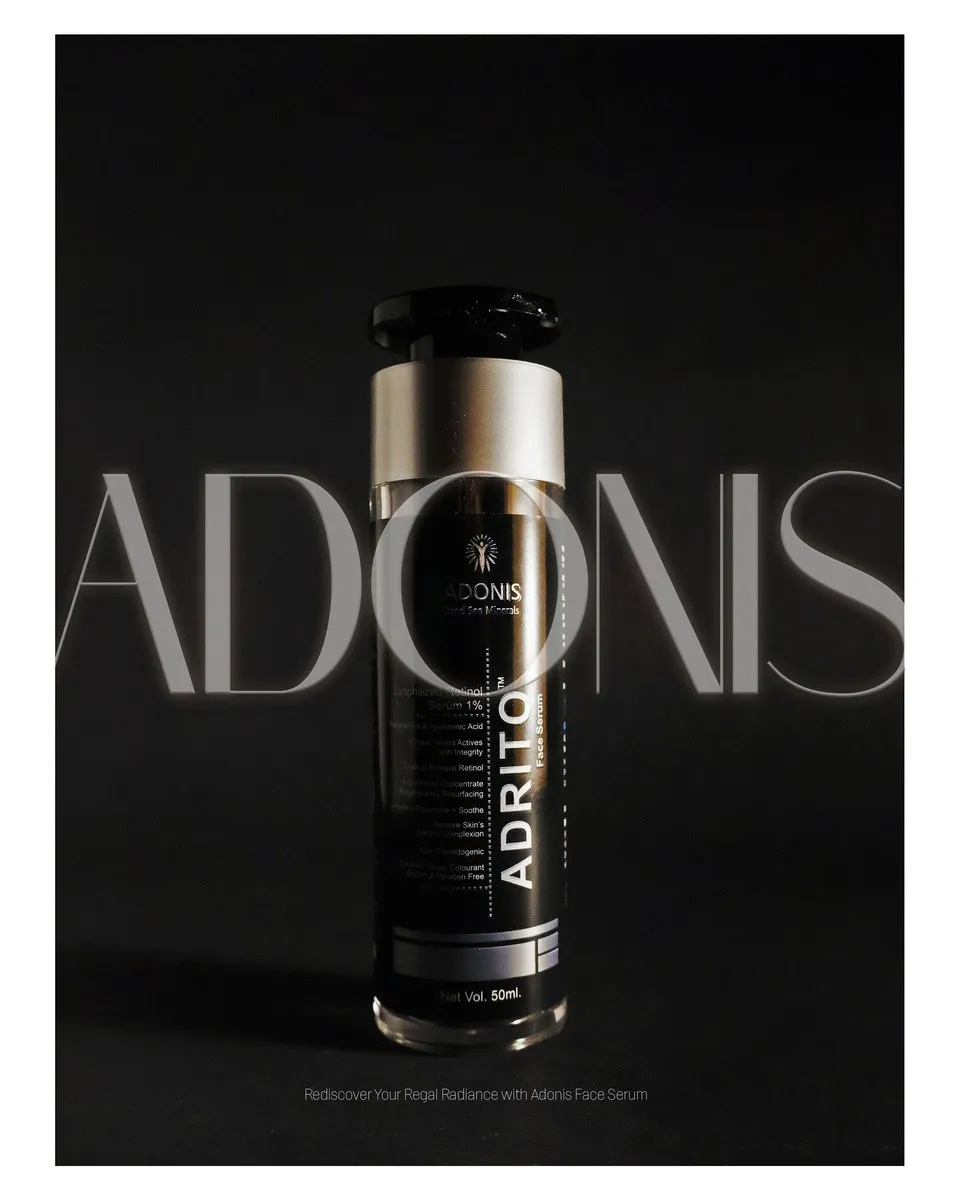 Adonis Adrito serum bottle with silver cap standing against a dark background