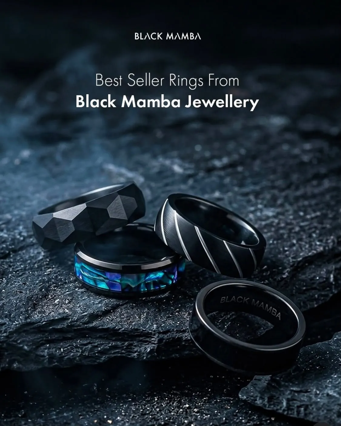 Four black Black Mamba rings, one with an abalone inlay, arranged on dark wet rock